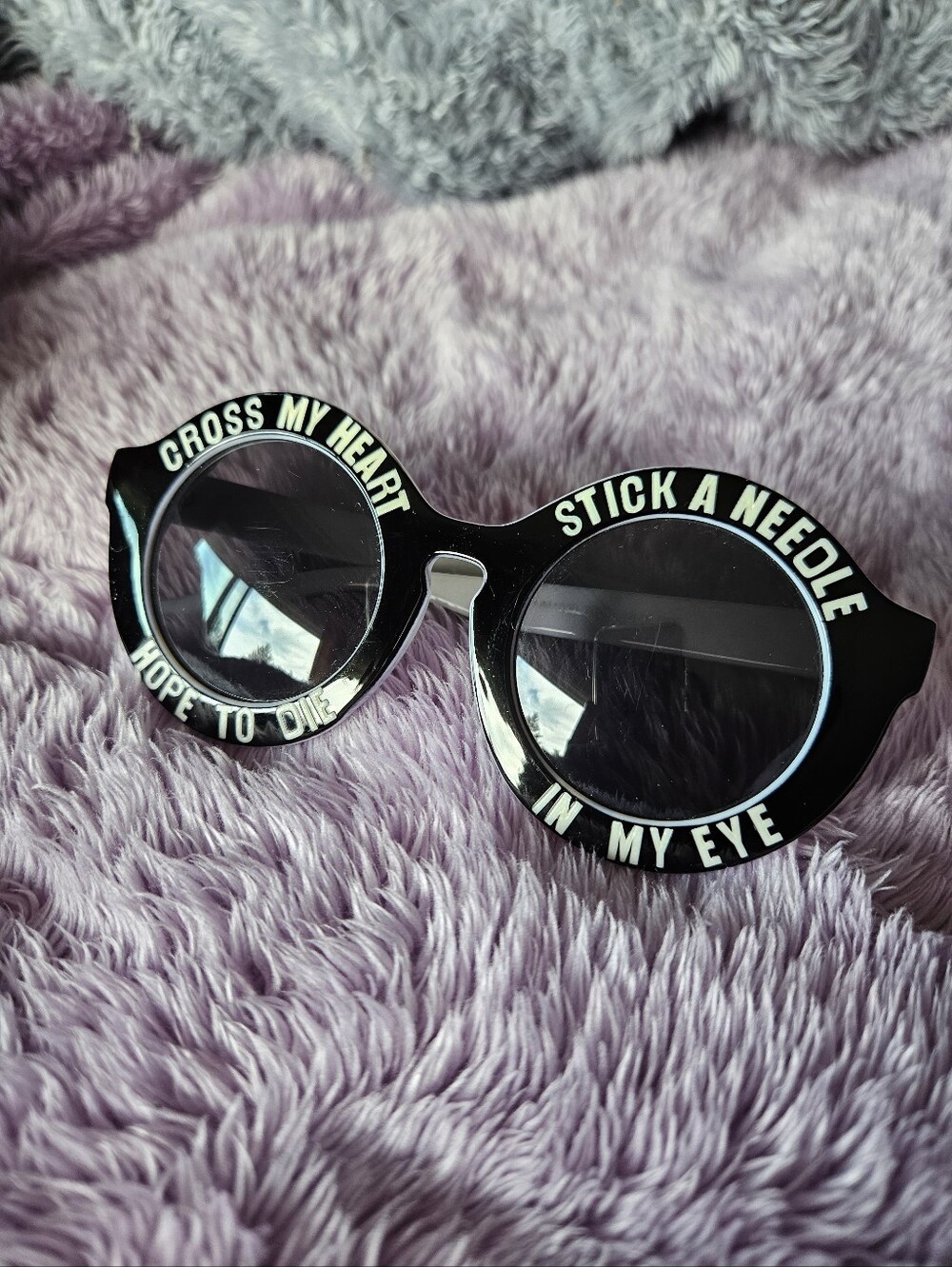 Cross My Heart Black Round Sunglasses with White Lettering Scene